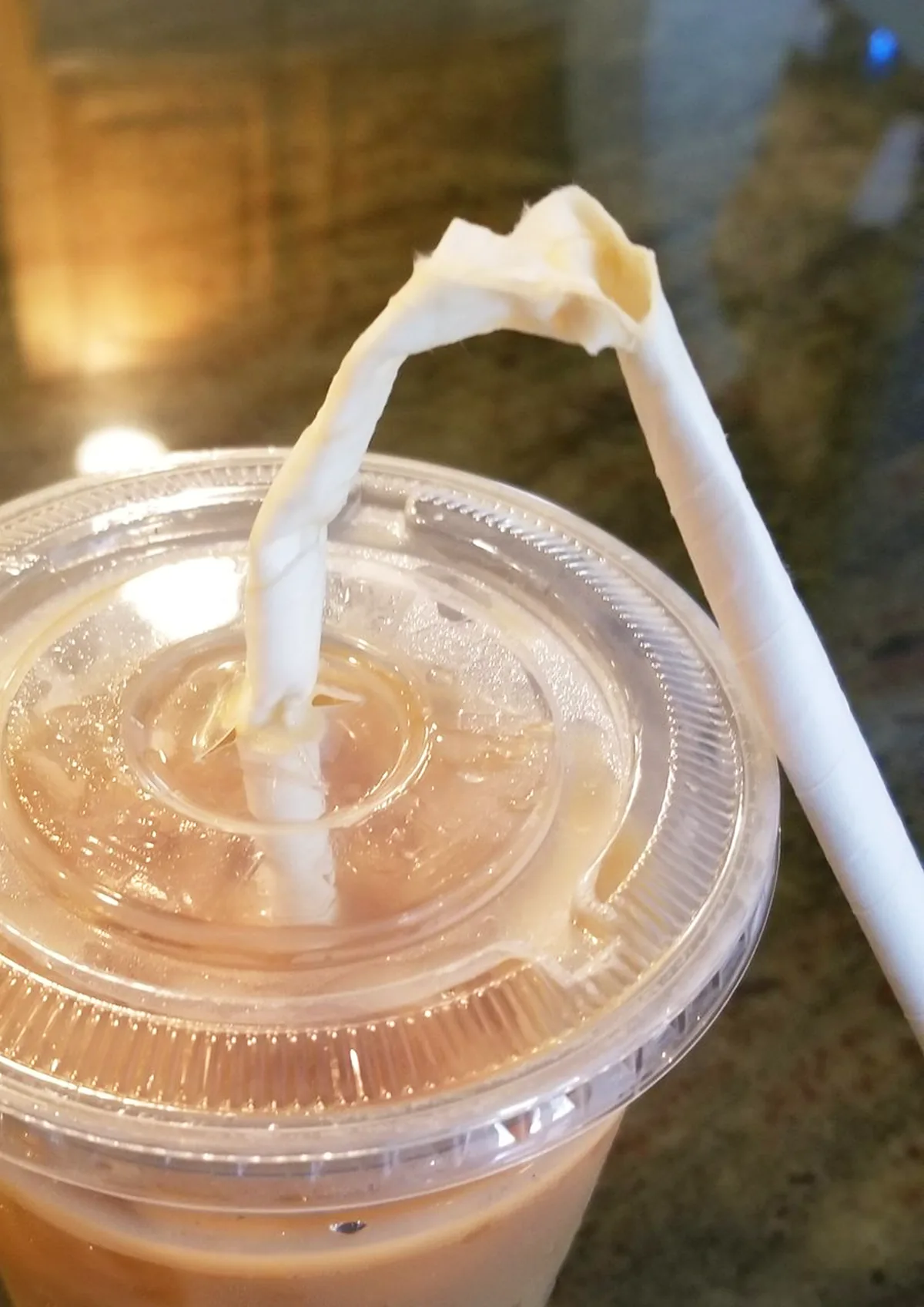 Soggy paper straw in an iced drink